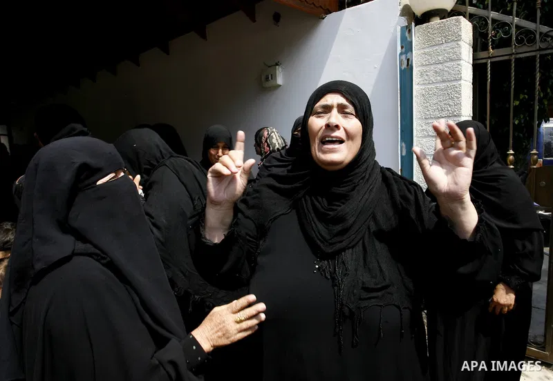 Relatives of two Palestinian children Mohammed and Oamr al-Brim, who witnesses said were killed in an Israeli air strike before a ceasefire was declared, mourn during their funeral in Khan Younis in the southern Gaza Str...