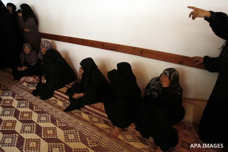 Relatives of two Palestinian children Mohammed and Oamr al-Brim, who witnesses said were killed in an Israeli air strike before a ceasefire was declared, mourn during their funeral in Khan Younis in the southern Gaza Str...