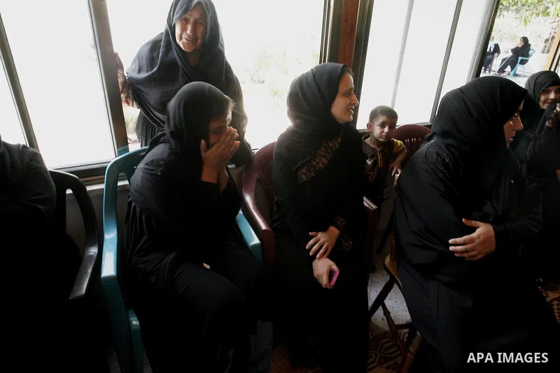 Relatives of two Palestinian children Mohammed and Oamr al-Brim, who witnesses said were killed in an Israeli air strike before a ceasefire was declared, mourn during their funeral in Khan Younis in the southern Gaza Str...