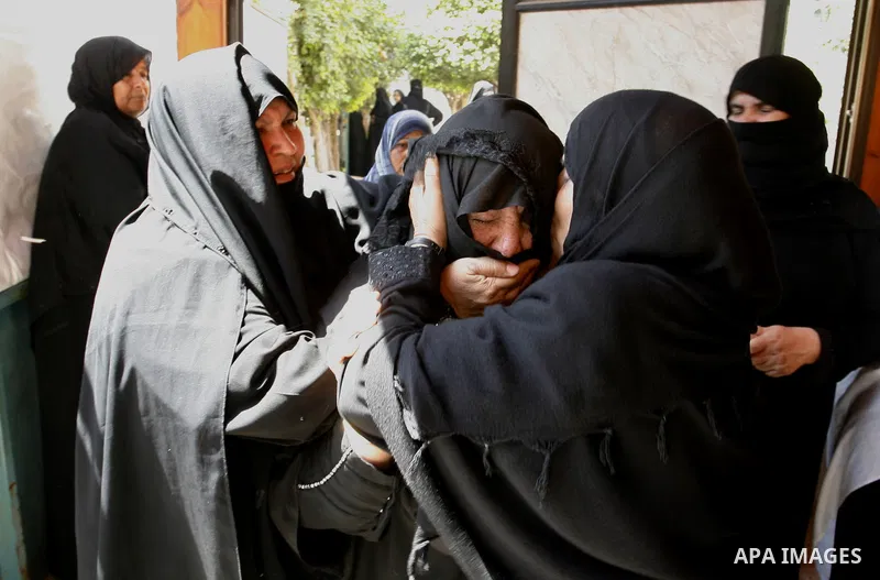 Relatives of two Palestinian children Mohammed and Oamr al-Brim, who witnesses said were killed in an Israeli air strike before a ceasefire was declared, mourn during their funeral in Khan Younis in the southern Gaza Str...