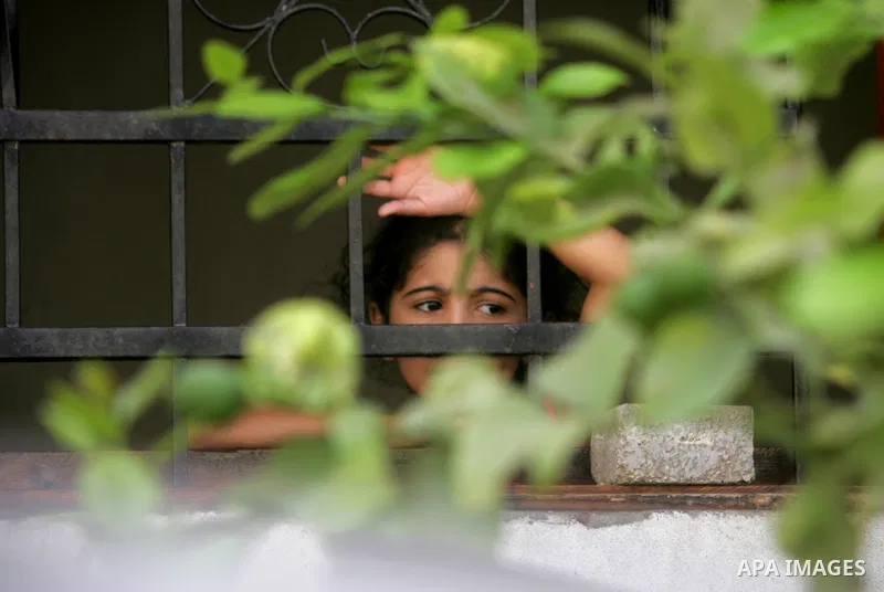 A Palestinian girl relative of two Palestinian children Mohammed and Oamr al-Brim, who witnesses said were killed in an Israeli air strike before a ceasefire was declared, mourns during their funeral in Khan Younis in th...