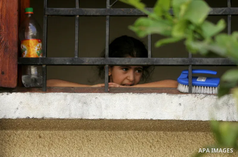A Palestinian girl relative of two Palestinian children Mohammed and Oamr al-Brim, who witnesses said were killed in an Israeli air strike before a ceasefire was declared, mourns during their funeral in Khan Younis in th...