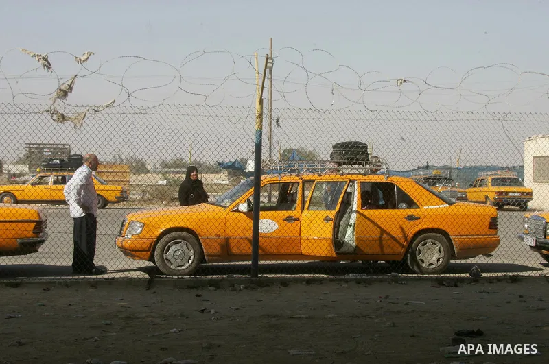 Palestinians, hoping to cross into Egypt, wait at the Rafah border crossing with Egypt in the southern Gaza Strip city of Rafha, on August 27, 2014. The open-ended ceasefire in the Gaza war between Israel and the Palesti...
