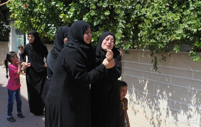 Relatives of two Palestinian children Mohammed and Omar al-Brim, who witnesses said were killed in an Israeli air strike before a ceasefire was declared, mourn during their funeral in Khan Younis in the southern Gaza Str...