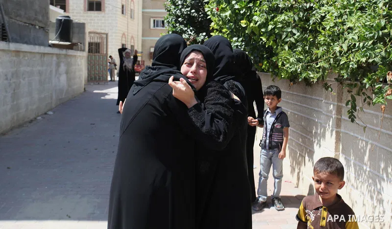 Relatives of two Palestinian children Mohammed and Omar al-Brim, who witnesses said were killed in an Israeli air strike before a ceasefire was declared, mourn during their funeral in Khan Younis in the southern Gaza Str...