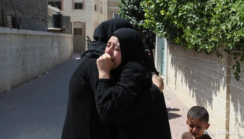 Relatives of two Palestinian children Mohammed and Omar al-Brim, who witnesses said were killed in an Israeli air strike before a ceasefire was declared, mourn during their funeral in Khan Younis in the southern Gaza Str...