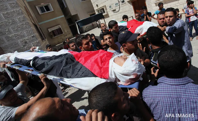 Mourners carry the bodies of two Palestinian children Mohammed and Omar al-Brim who witnesses said were killed in an Israeli air strike before a ceasefire was declared, during their funeral in Khan Younis in the southern...