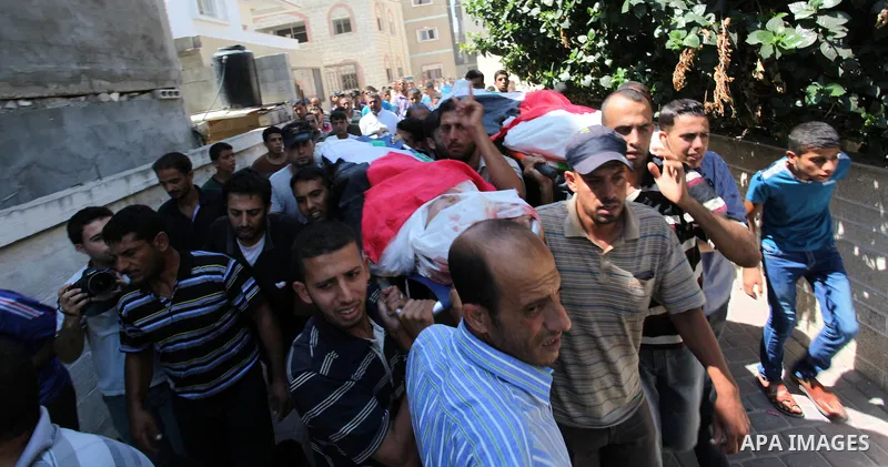 Mourners carry the bodies of two Palestinian children Mohammed and Omar al-Brim who witnesses said were killed in an Israeli air strike before a ceasefire was declared, during their funeral in Khan Younis in the southern...