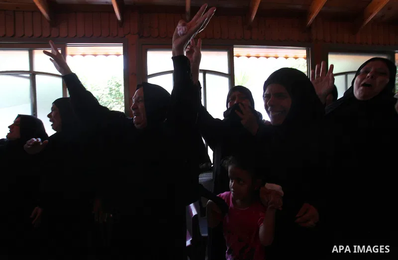 Relatives of two Palestinian children Mohammed and Omar al-Brim, who witnesses said were killed in an Israeli air strike before a ceasefire was declared, mourn during their funeral in Khan Younis in the southern Gaza Str...