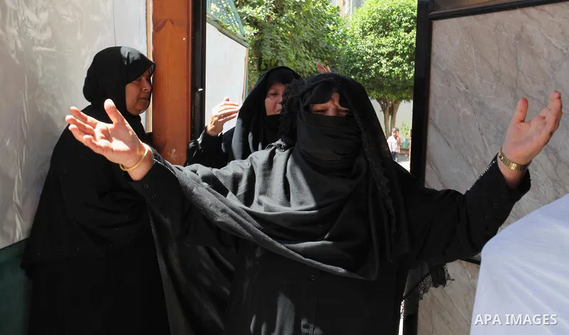 Relatives of two Palestinian children Mohammed and Omar al-Brim, who witnesses said were killed in an Israeli air strike before a ceasefire was declared, mourn during their funeral in Khan Younis in the southern Gaza Str...