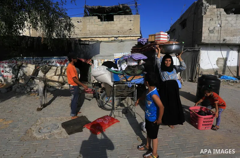 Palestinians collect their baggage as they prepare to return home in Gaza City's Shejaiya neighbourhood on August 27, 2014, following the long-term truce agreed between Israel and the Palestinians. The open-ended ceasefi...