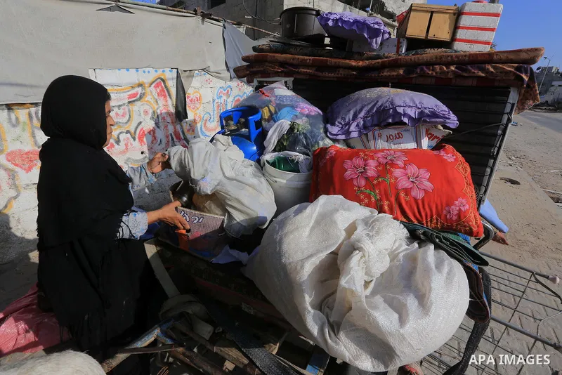 Palestinians collect their baggage as they prepare to return home in Gaza City's Shejaiya neighbourhood on August 27, 2014, following the long-term truce agreed between Israel and the Palestinians. The open-ended ceasefi...