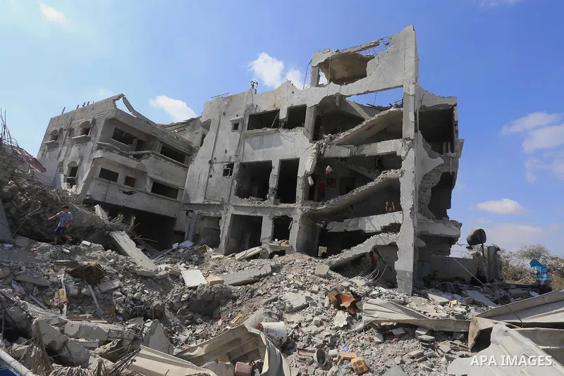 Palestinians sit on the rubble of their house, which witnesses said was destroyed in an Israeli offensive, after a ceasefire was declared, in the east of Gaza City August 27, 2014. The open-ended ceasefire in the Gaza wa...