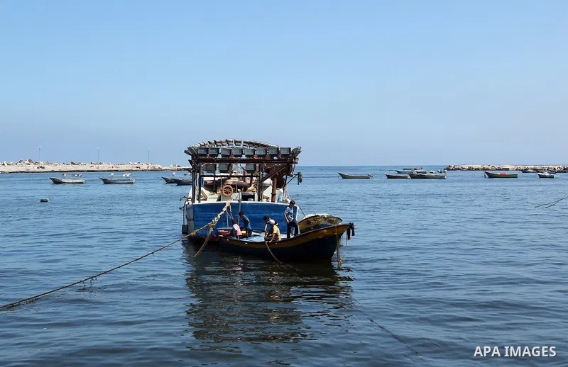 Palestinian fishermen retrieve their boats at the beach in Gaza city on Aug. 27, 2014. An open-ended ceasefire in the Gaza war between Israel and the Palestinians held on Wednesday as Prime Minister Benjamin Netanyahu fa...