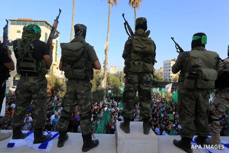 Hamas militants celebrate with people what they said was a victory over Israel, in Gaza City August 27, 2014. The agreement, effective from 1600 GMT on August 26, saw the warring sides agree to a "permanent" ceasefire wh...