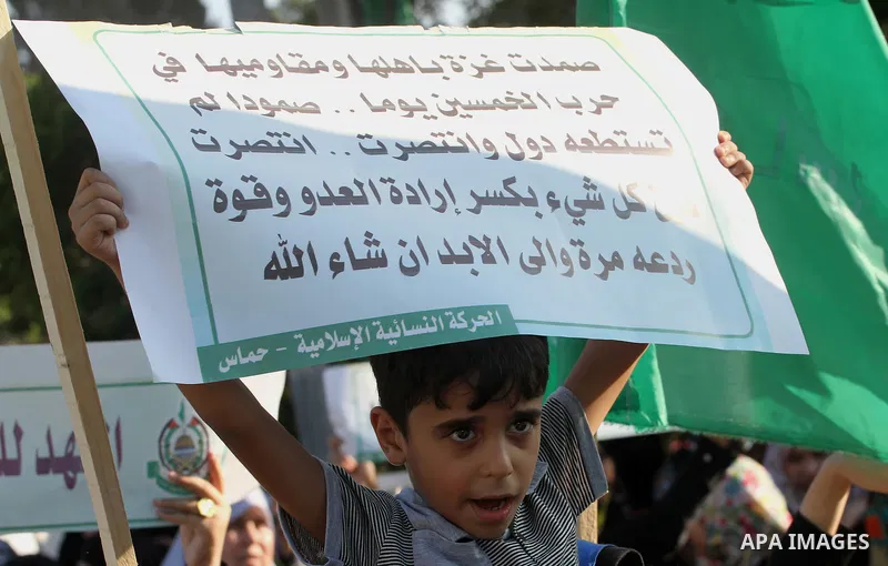 A Palestinian boy celebrates in Gaza City on August 27, 2014, during a rally following a deal hailed by Israel and the Islamist Hamas movement as 'victory' in the 50-day war. The agreement, effective from 1600 GMT on Aug...