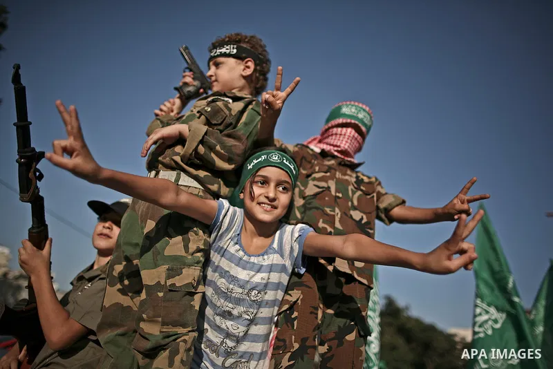 Palestinians Hamas supporters celebrate with people a victory over Israel, in Gaza City August 27, 2014. An open-ended ceasefire in the Gaza war held on Wednesday as Prime Minister Benjamin Netanyahu faced strong critici...