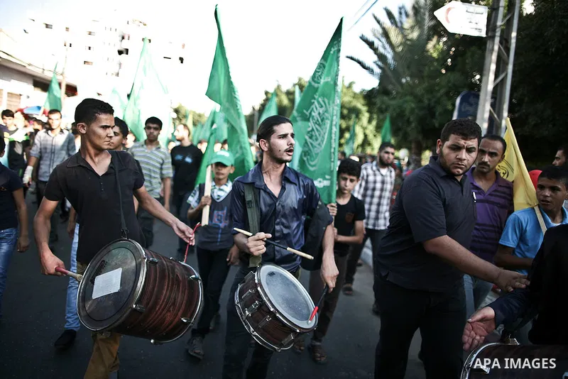 Palestinians Hamas supporters celebrate with people a victory over Israel, in Gaza City August 27, 2014. An open-ended ceasefire in the Gaza war held on Wednesday as Prime Minister Benjamin Netanyahu faced strong critici...