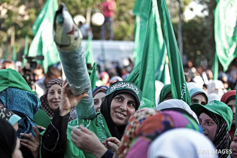 Palestinians Hamas supporters celebrate with people a victory over Israel, in Gaza City August 27, 2014. An open-ended ceasefire in the Gaza war held on Wednesday as Prime Minister Benjamin Netanyahu faced strong critici...