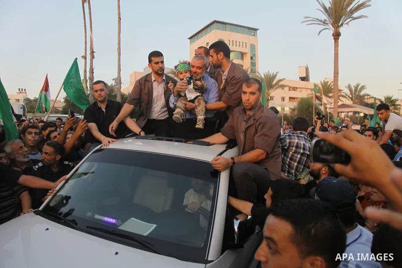 Hamas top leader in the Gaza Strip Ismail Haniya waves to the crowd during a rally in Gaza City on August 27, 2014, following a deal hailed by Israel and the Islamist movement as 'victory' in the 50-day war. The agreemen...