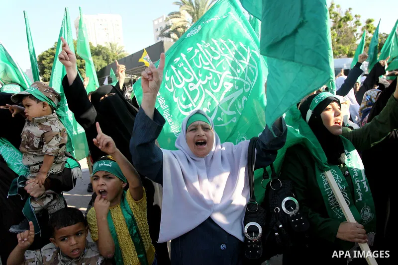 Palestinians Hamas supporters celebrate with people a victory over Israel, in Gaza City August 27, 2014. An open-ended ceasefire in the Gaza war held on Wednesday as Prime Minister Benjamin Netanyahu faced strong critici...