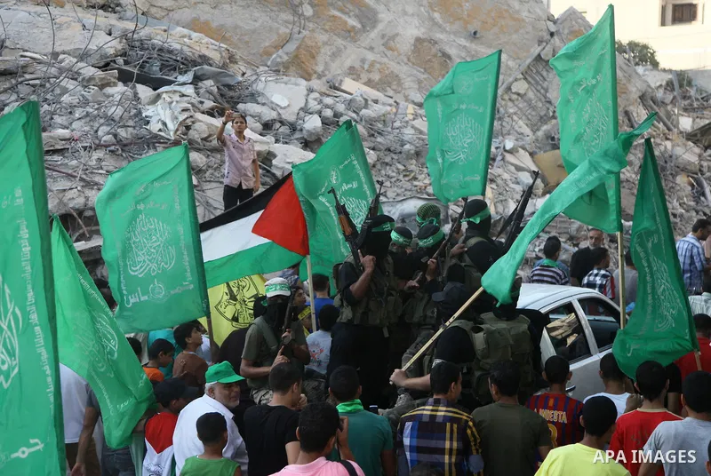 Palestinian militants from the Ezzedine al-Qassam Brigades, Hamas' armed wing, take part in a rally in Gaza City on August 27, 2014, following a deal hailed by Israel and the Islamist movement as 'victory' in the 50-day...