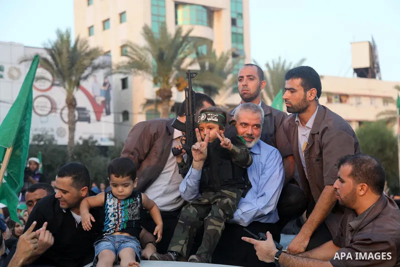 Hamas top leader in the Gaza Strip Ismail Haniya waves to the crowd during a rally in Gaza City on August 27, 2014, following a deal hailed by Israel and the Islamist movement as 'victory' in the 50-day war. The agreemen...