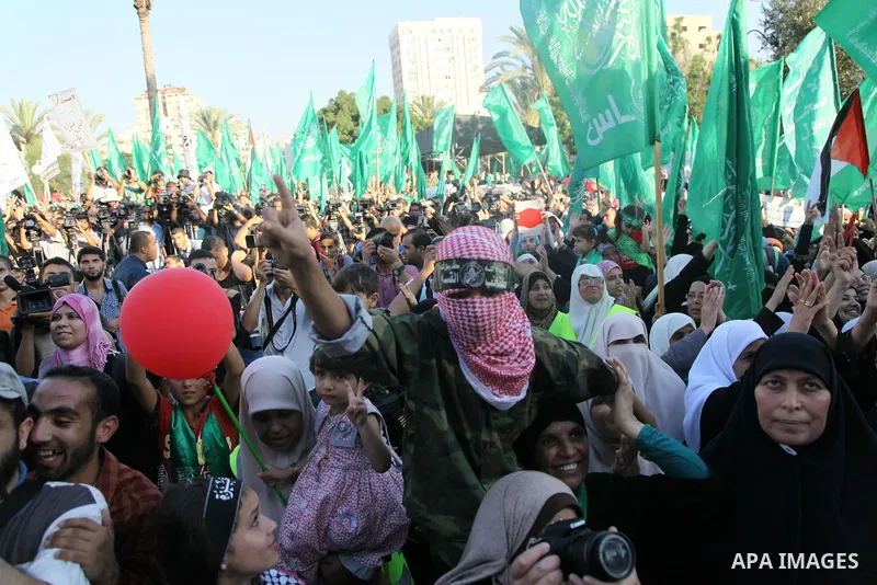 Palestinians Hamas supporters celebrate with people a victory over Israel, in Gaza City August 27, 2014. An open-ended ceasefire in the Gaza war held on Wednesday as Prime Minister Benjamin Netanyahu faced strong critici...