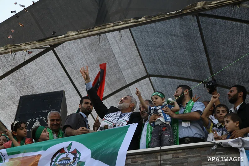 Hamas top leader in the Gaza Strip Ismail Haniya waves to the crowd during a rally in Gaza City on August 27, 2014, following a deal hailed by Israel and the Islamist movement as 'victory' in the 50-day war. The agreemen...