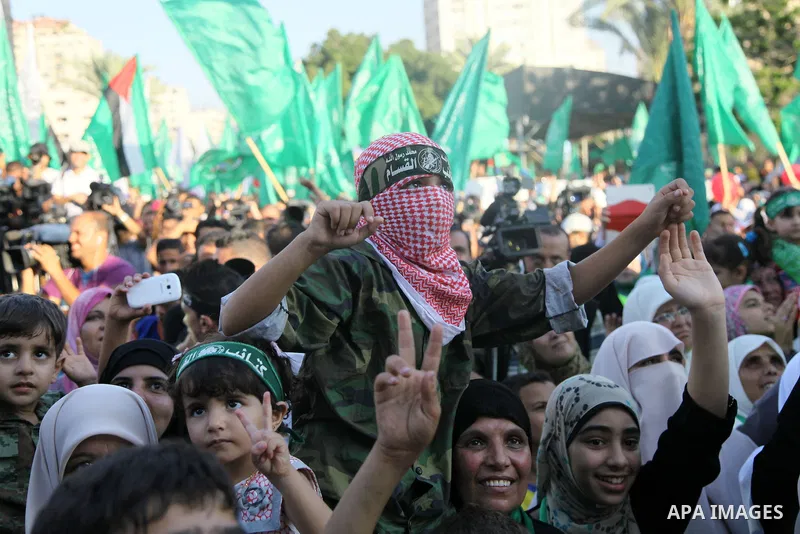 Palestinians Hamas supporters celebrate with people a victory over Israel, in Gaza City August 27, 2014. An open-ended ceasefire in the Gaza war held on Wednesday as Prime Minister Benjamin Netanyahu faced strong critici...