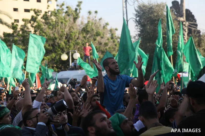 Palestinians Hamas supporters celebrate with people a victory over Israel, in Gaza City August 27, 2014. An open-ended ceasefire in the Gaza war held on Wednesday as Prime Minister Benjamin Netanyahu faced strong critici...