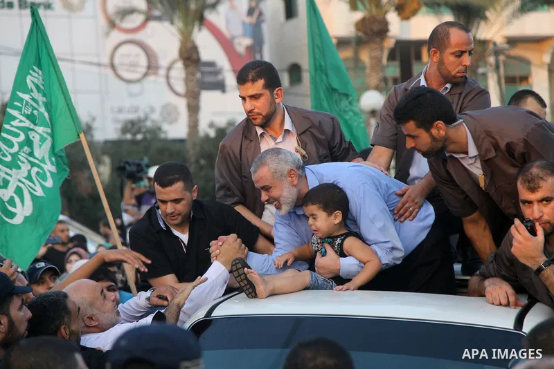 Hamas top leader in the Gaza Strip Ismail Haniya waves to the crowd during a rally in Gaza City on August 27, 2014, following a deal hailed by Israel and the Islamist movement as 'victory' in the 50-day war. The agreemen...