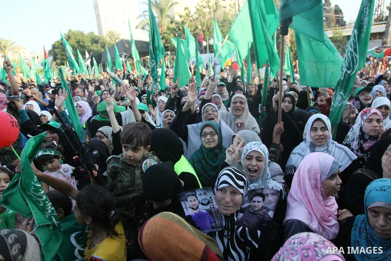 Palestinians Hamas supporters celebrate with people a victory over Israel, in Gaza City August 27, 2014. An open-ended ceasefire in the Gaza war held on Wednesday as Prime Minister Benjamin Netanyahu faced strong critici...