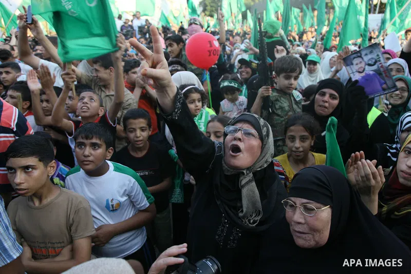 Palestinians Hamas supporters celebrate with people a victory over Israel, in Gaza City August 27, 2014. An open-ended ceasefire in the Gaza war held on Wednesday as Prime Minister Benjamin Netanyahu faced strong critici...