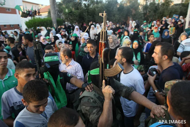 Palestinian militants from the Ezzedine al-Qassam Brigades, Hamas' armed wing, attend a rally in Gaza City on August 27, 2014, following a deal hailed by Israel and the Islamist movement as 'victory' in the 50-day war. T...