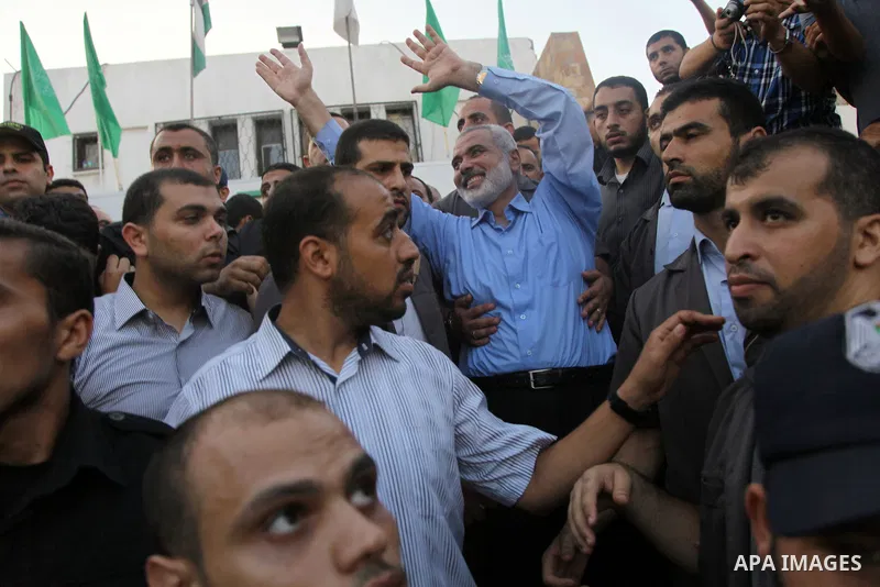 Hamas top leader in the Gaza Strip Ismail Haniya waves to the crowd during a rally in Gaza City on August 27, 2014, following a deal hailed by Israel and the Islamist movement as 'victory' in the 50-day war. The agreemen...