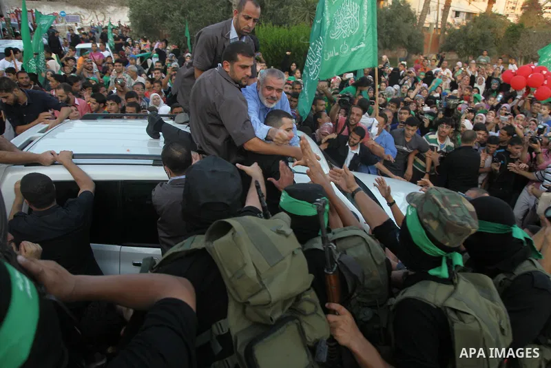 Hamas top leader in the Gaza Strip Ismail Haniya waves to the crowd during a rally in Gaza City on August 27, 2014, following a deal hailed by Israel and the Islamist movement as 'victory' in the 50-day war. The agreemen...