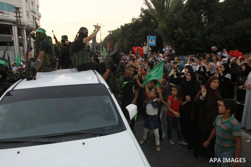 Palestinians Hamas supporters celebrate with people a victory over Israel, in Gaza City August 27, 2014. An open-ended ceasefire in the Gaza war held on Wednesday as Prime Minister Benjamin Netanyahu faced strong critici...