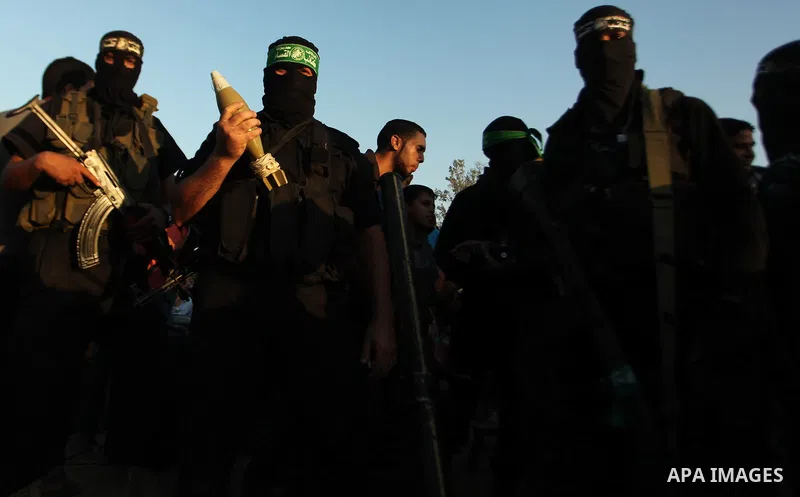 Palestinian militants of Izzedine al-Qassam Brigades, military wing of Hamas, and their supporters celebrate a victory rally at the debris of destroyed houses in Shijaiyah, neighborhood of Gaza City, in the northern Gaza...