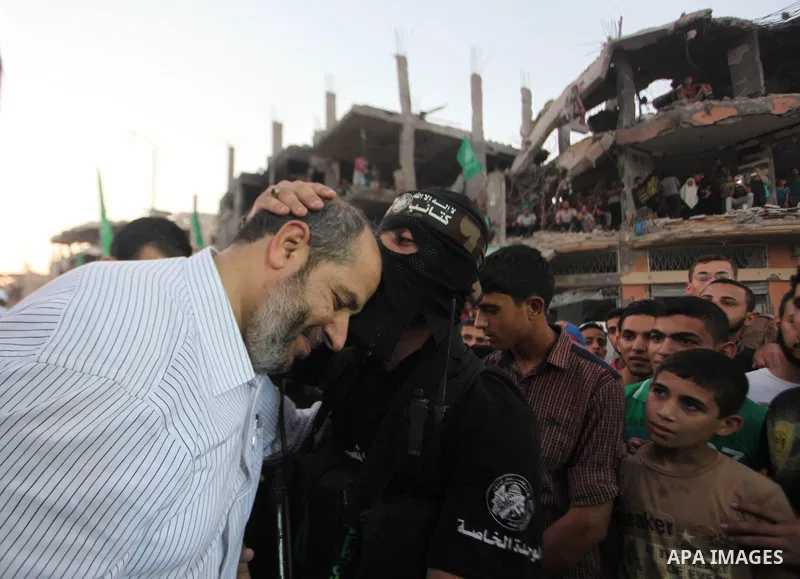 Palestinian militants of Izzedine al-Qassam Brigades, military wing of Hamas, and their supporters celebrate a victory rally at the debris of destroyed houses in Shijaiyah, neighborhood of Gaza City, in the northern Gaza...