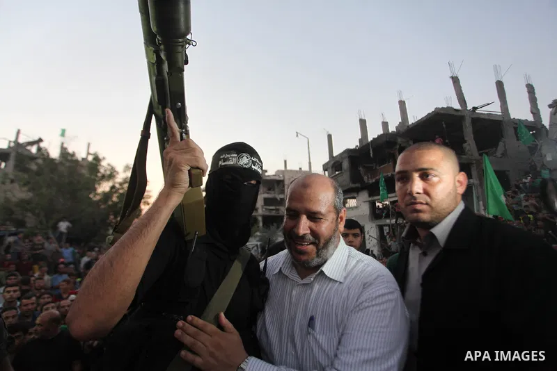 Palestinian militants of Izzedine al-Qassam Brigades, military wing of Hamas, and their supporters celebrate a victory rally at the debris of destroyed houses in Shijaiyah, neighborhood of Gaza City, in the northern Gaza...