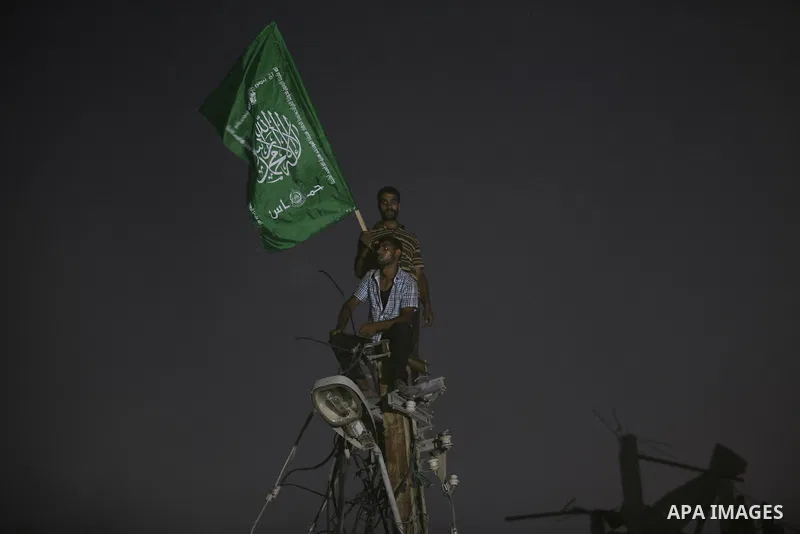 Palestinian militants of Izzedine al-Qassam Brigades, military wing of Hamas, and their supporters celebrate a victory rally at the debris of destroyed houses in Shijaiyah, neighborhood of Gaza City, in the northern Gaza...