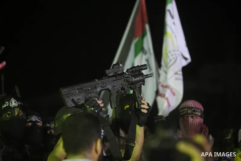 Palestinian militants of Izzedine al-Qassam Brigades, military wing of Hamas, and their supporters celebrate a victory rally at the debris of destroyed houses in Shijaiyah, neighborhood of Gaza City, in the northern Gaza...