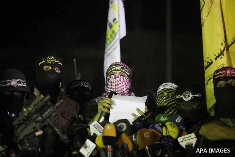 Palestinian militants of Izzedine al-Qassam Brigades, military wing of Hamas, and their supporters celebrate a victory rally at the debris of destroyed houses in Shijaiyah, neighborhood of Gaza City, in the northern Gaza...