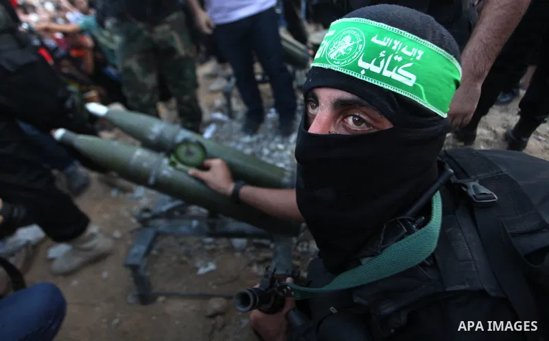 Palestinian militants of Izzedine al-Qassam Brigades, military wing of Hamas, and their supporters celebrate a victory rally at the debris of destroyed houses in Shijaiyah, neighborhood of Gaza City, in the northern Gaza...