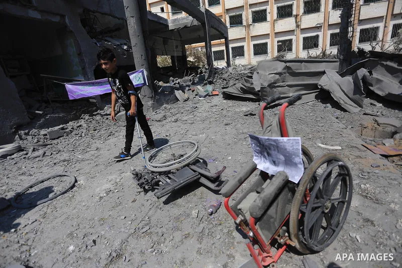 A Palestinian disabled boy walks past the rubble of the destroyed a rehabilitation centre, in Gaza city August 28, 2014. Israel and Palestinians both boasted of victory in the Gaza war but analysts say Hamas received onl...