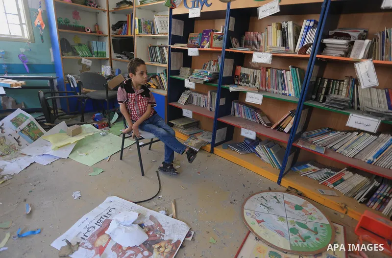 A Palestinian disabled child sits on a chair as he look at the rubble of the destroyed a rehabilitation centre, in Gaza city August 28, 2014. Israel and Palestinians both boasted of victory in the Gaza war but analysts s...