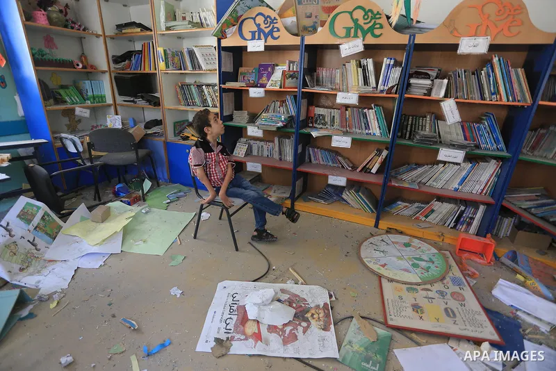 A Palestinian disabled child sits on a chair as he look at the rubble of the destroyed a rehabilitation centre, in Gaza city August 28, 2014. Israel and Palestinians both boasted of victory in the Gaza war but analysts s...
