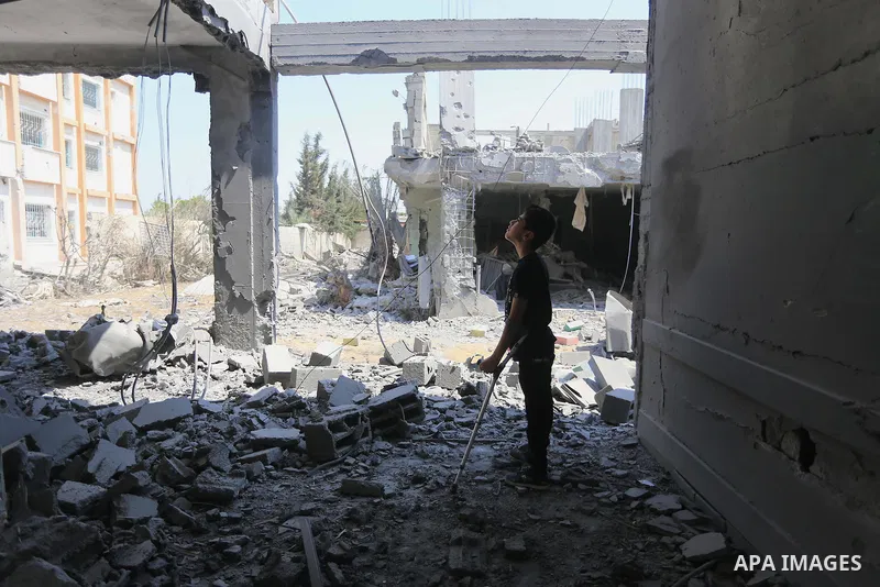 A Palestinian boy looks at the rubble of the destroyed a rehabilitation centre, in Gaza city August 28, 2014. Israel and Palestinians both boasted of victory in the Gaza war but analysts say Hamas received only promises...