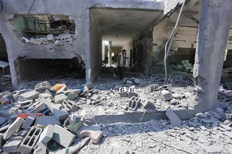 A Palestinian man inspects the rubble of the destroyed a rehabilitation centre, in Gaza city August 28, 2014. Israel and Palestinians both boasted of victory in the Gaza war but analysts say Hamas received only promises...